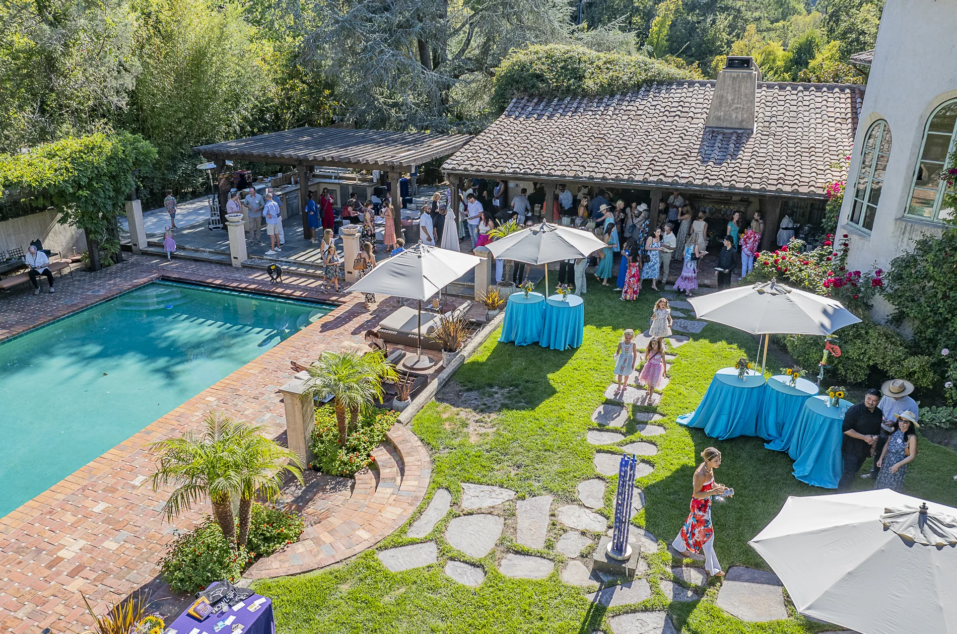 Guests gathering near the garden and pool